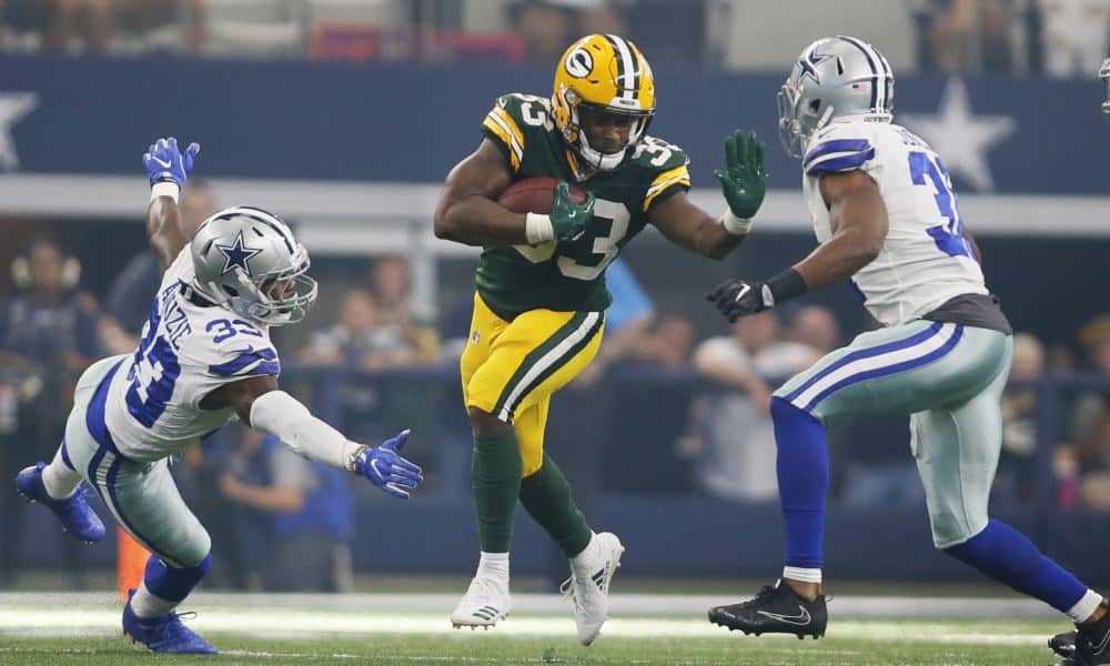 Oct 8, 2017; Arlington, TX, USA; Green Bay Packers running back Aaron Jones (33) runs against Dallas Cowboys safety Byron Jones (31) in the third quarter at AT&amp;T Stadium. Mandatory Credit: Tim Heitman-USA TODAY Sports