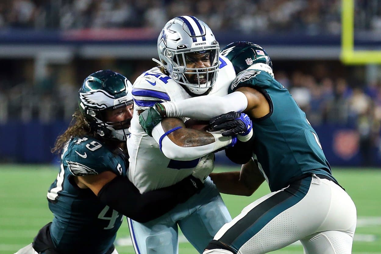 ARLINGTON, TEXAS - SEPTEMBER 27: Alex Singleton #49 and Steven Nelson #3 of the Philadelphia Eagles try to stop the run by Ezekiel Elliott #21 of the Dallas Cowboys in the second half at AT&amp;T Stadium on September 27, 2021 in Arlington, Texas. (Photo by Richard Rodriguez/Getty Images)