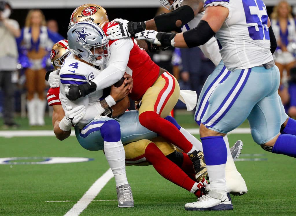 ARLINGTON, TEXAS - JANUARY 16: Samson Ebukam #56 and Nick Bosa #97 of the San Francisco 49ers sack Dak Prescott #4 of the Dallas Cowboys during the first quarter in the NFC Wild Card Playoff game at AT&amp;T Stadium on January 16, 2022 in Arlington, Texas. (Photo by Richard Rodriguez/Getty Images)