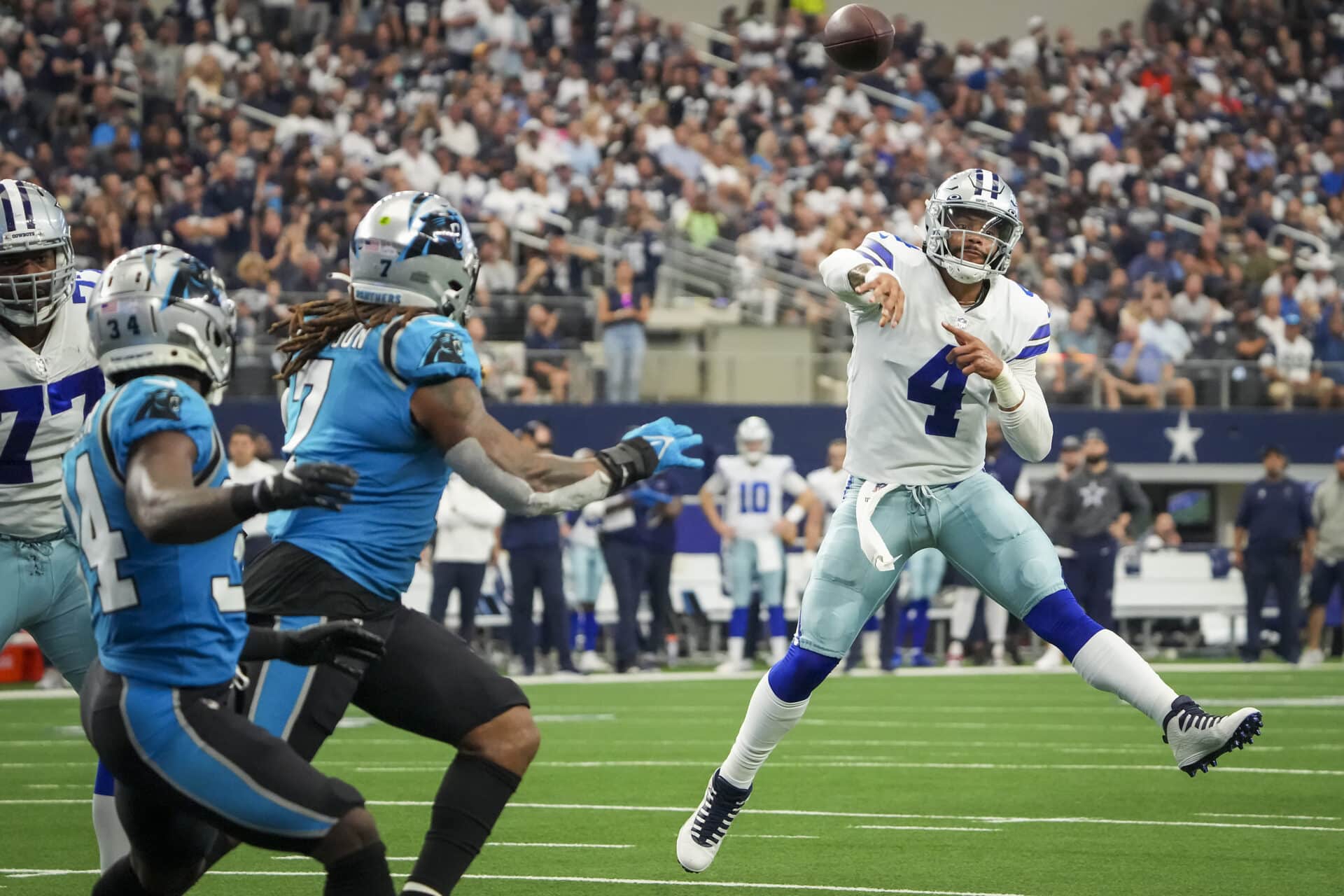 Dallas Cowboys quarterback Dak Prescott (4) makes a throw on the run during the first half of an NFL football game against the Carolina Panthers at AT&amp;T Stadium on Sunday, Oct. 3, 2021, in Arlington. (Smiley N. Pool/The Dallas Morning News)