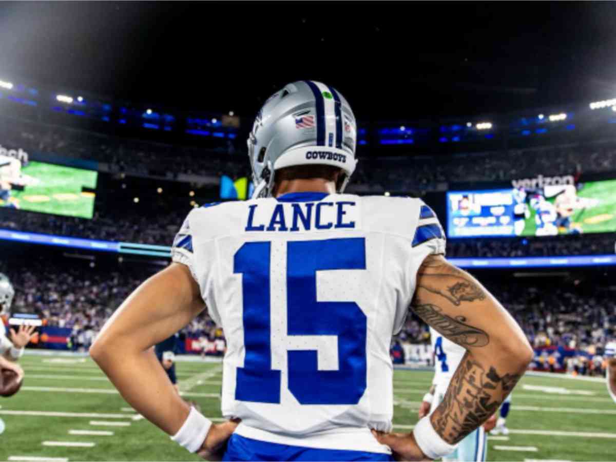 Football player with "Lance" and number 15 on jersey stands with hands on hips, facing a stadium full of spectators.